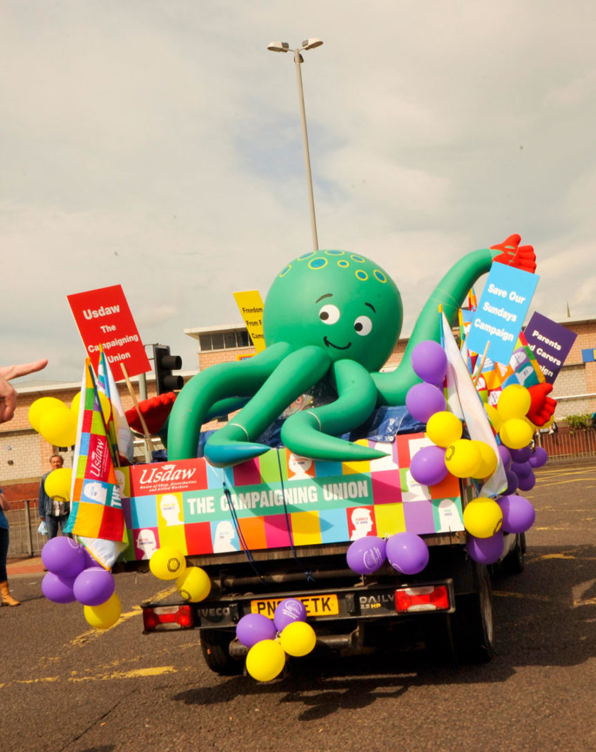 Inflatable baby octopus riding in the back of a lorry