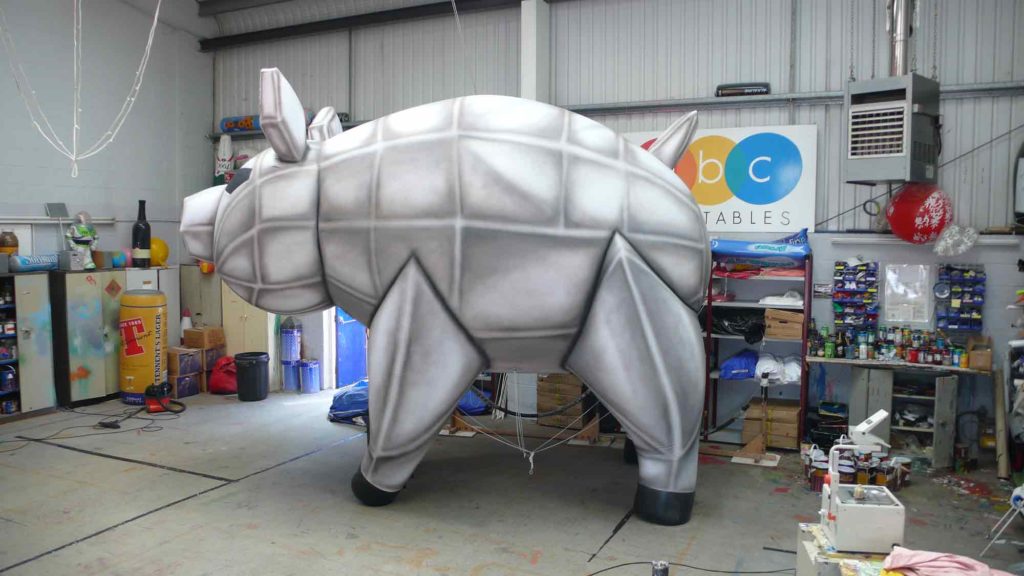 Grey robotic looking giant inflatable pig in our workshop