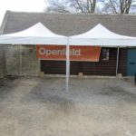 Marquee provides shelter in car park area by building