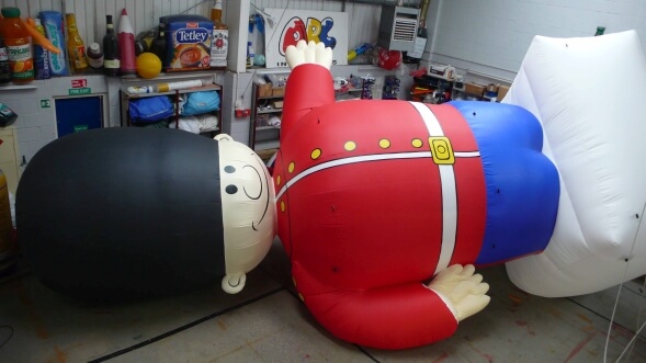 inflatable guardsman lying on his side in workshop