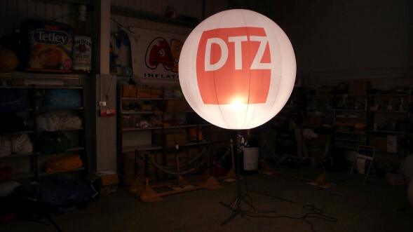 Inflatable sphere on stand with light in it in dark room