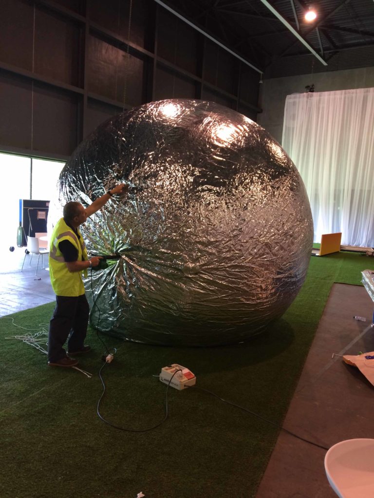 inflating a giant silver sphere