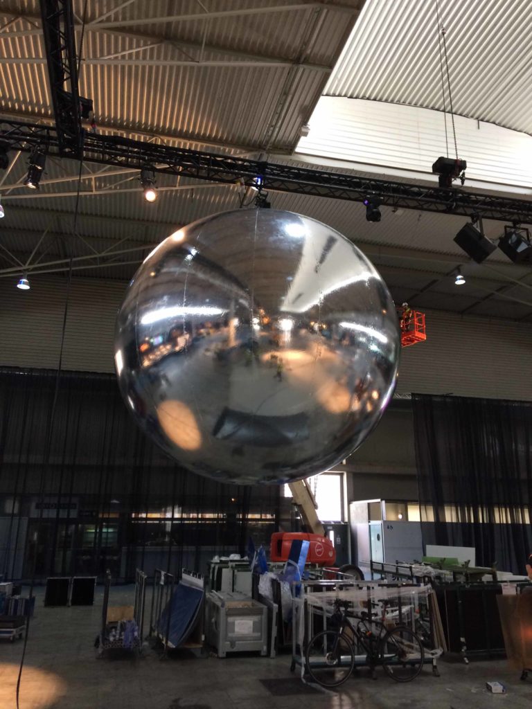 one giant inflatable mirror balls suspended from ceiling
