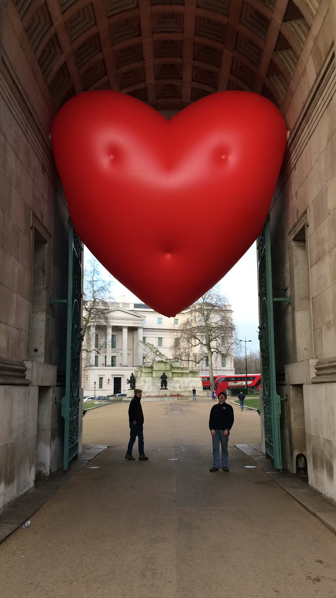 Inflatable chubby heart in archway with 2 people below