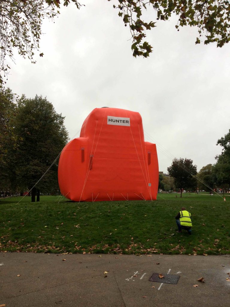 Giant red inflatable backpack with man in hi vis
